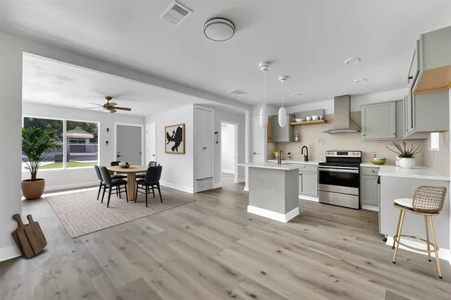 a kitchen with granite countertop a stove a sink and a refrigerator