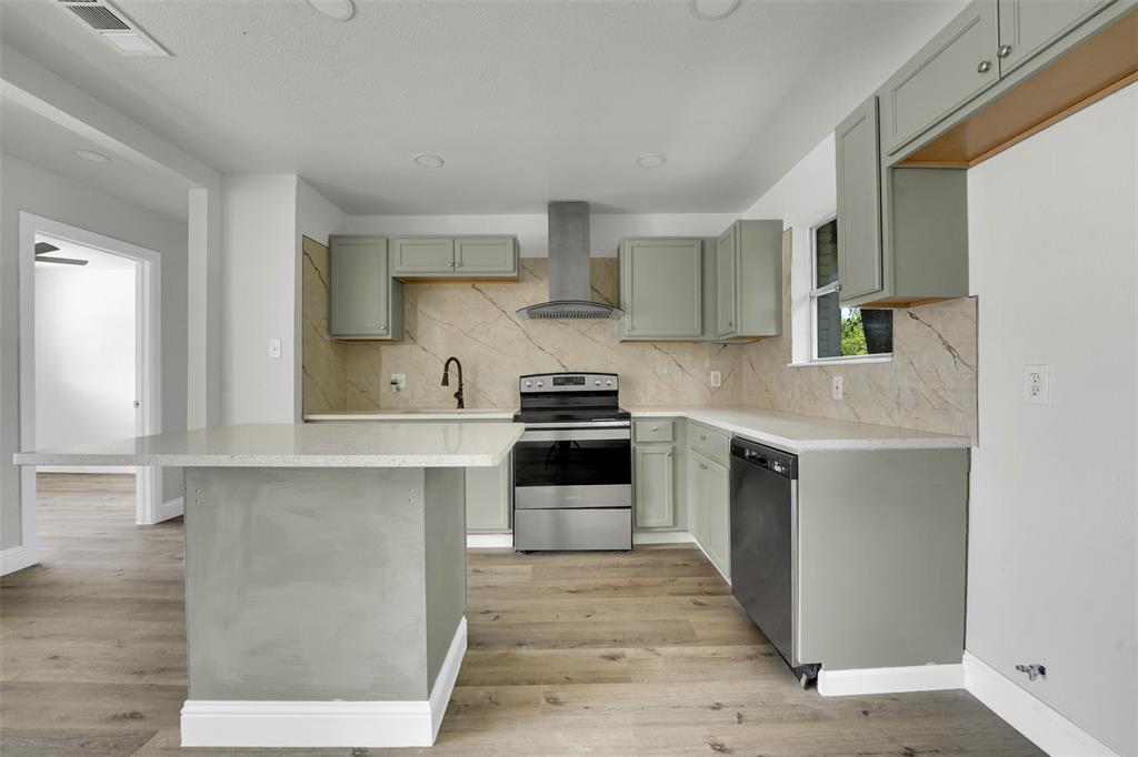 1507 East Lovers Lane Arlington, TX 76010 - Photo 8 of 18 a kitchen with stainless steel appliances granite countertop a stove and white cabinets