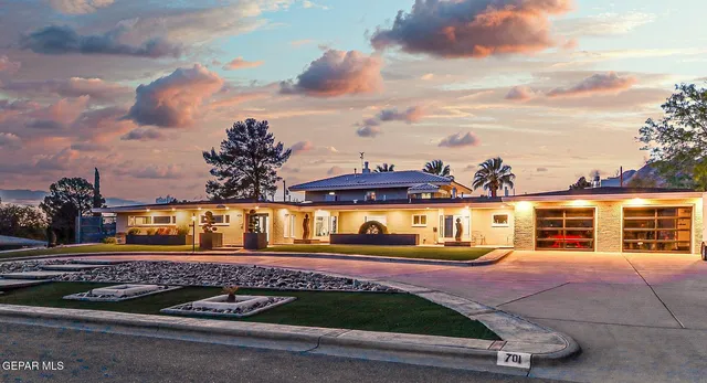 a front view of a house with a yard table and chairs