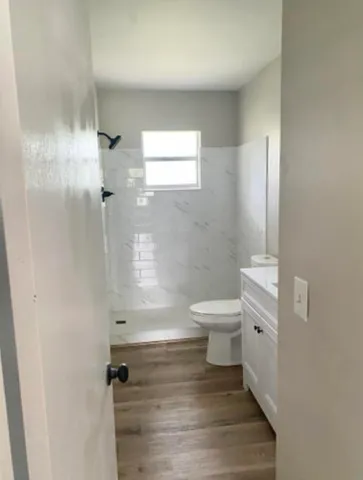a bathroom with a toilet and a shower