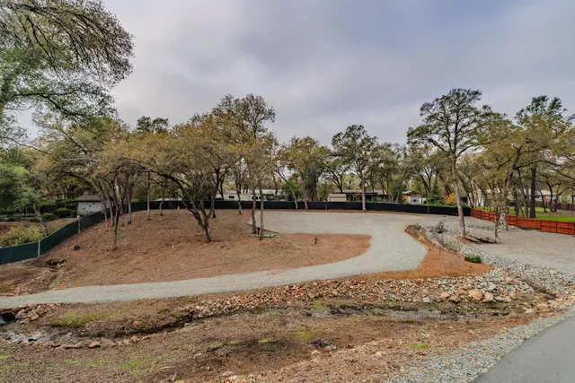 a aerial view of a house with a yard and trees