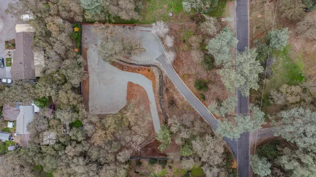 an aerial view of mountain with trees all around