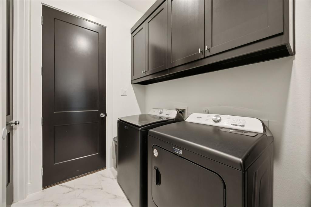 7024 Prairie Ridge Road Argyle, TX 76226 - Photo 31 of 40 Spacious Laundry Room Featuring Built-In Cabinets for Ample Storage