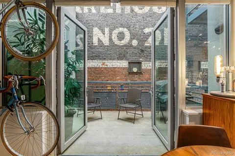 a view of a balcony with table and chairs
