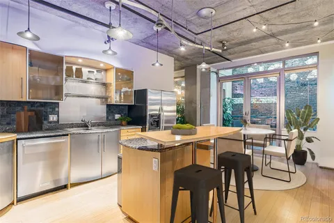 a kitchen with stainless steel appliances granite countertop a stove and cabinets