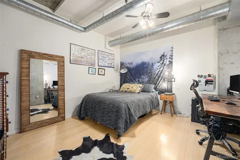 a bedroom with a bed and a desk