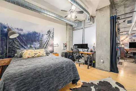 a bedroom with a bed a table and chair