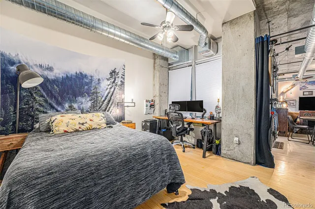 a bedroom with a bed a table and chair