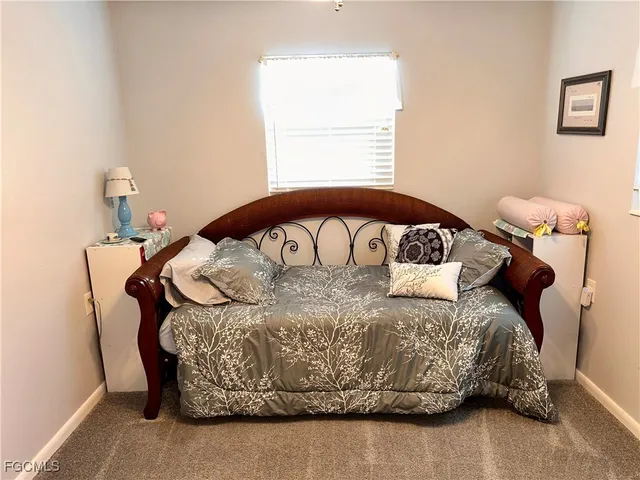 a bed sitting in a bedroom next to a window