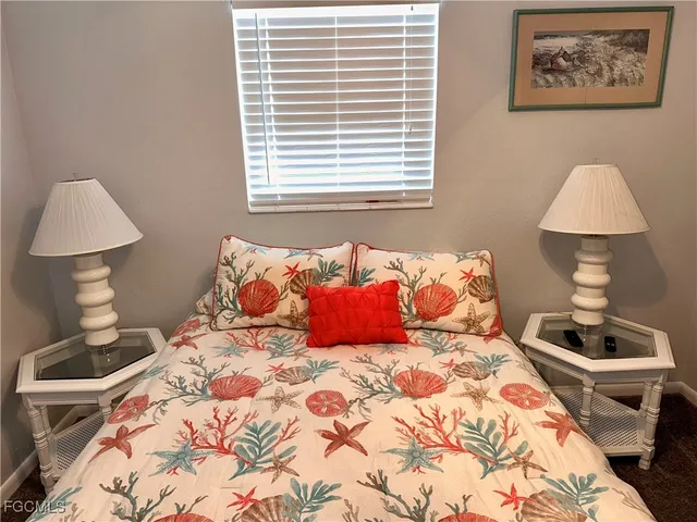 a bedroom with a bed and a lamp