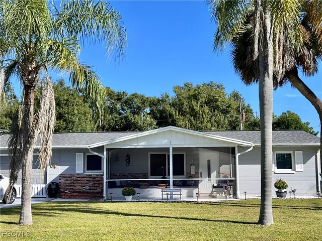 a front view of house with yard and outdoor seating
