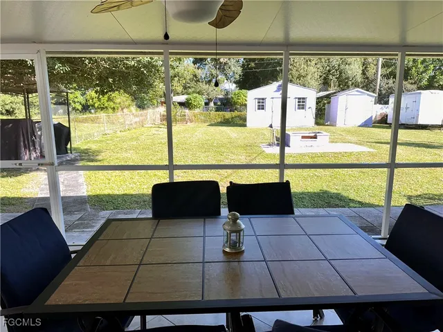 a view of a porch with furniture and a yard