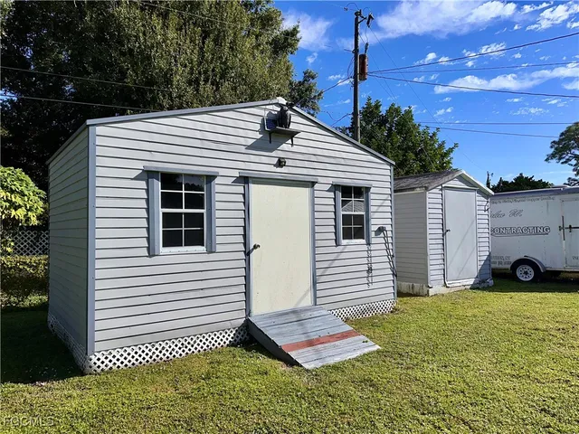 a view of a house with a yard and sitting area