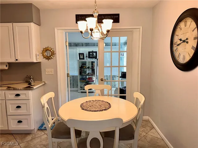 a view of a dining room with furniture and chandelier