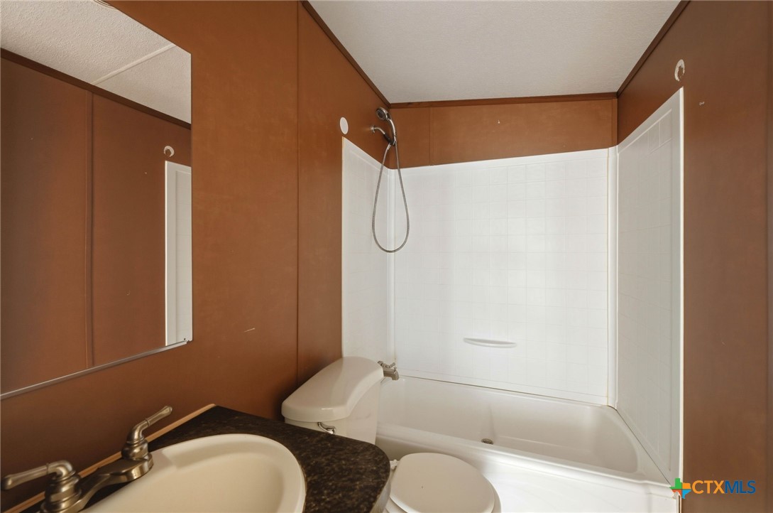 770 Private Road 3447 Kempner, TX 76539 - Photo 17 of 34 a bathroom with a granite countertop sink toilet and shower
