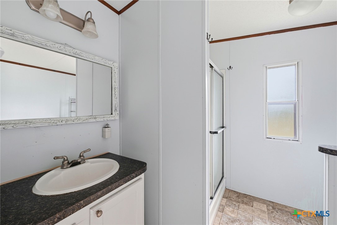 770 Private Road 3447 Kempner, TX 76539 - Photo 21 of 34 a bathroom with a granite countertop sink and a mirror
