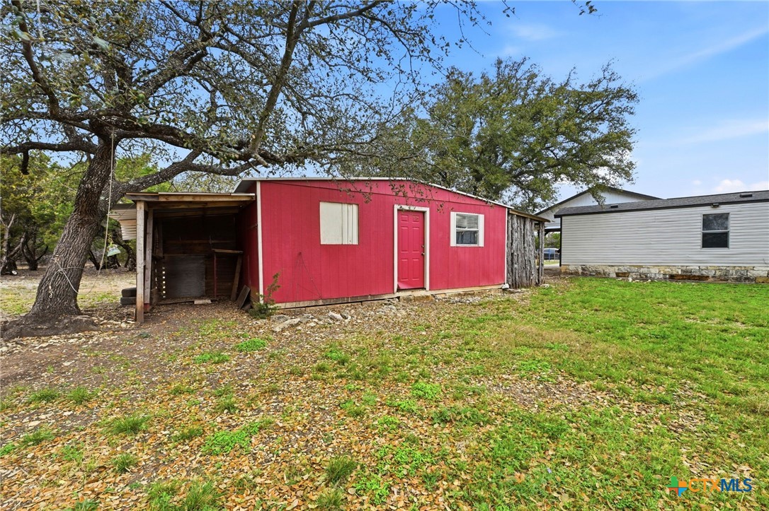 770 Private Road 3447 Kempner, TX 76539 - Photo 27 of 34 a red brick house with a big yard and large trees