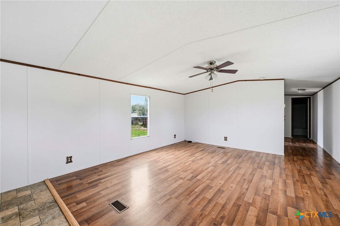 770 Private Road 3447 Kempner, TX 76539 - Photo 6 of 34 an empty room with wooden floor and windows