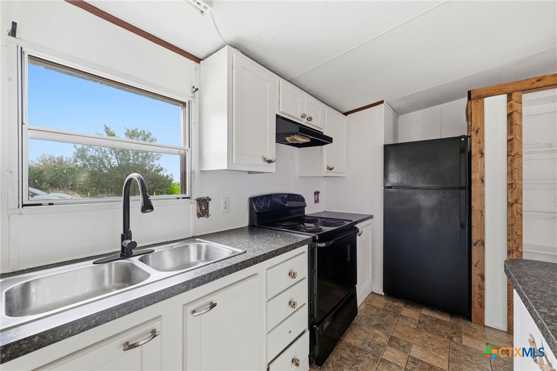 770 Private Road 3447 Kempner, TX 76539 - Photo 9 of 34 a kitchen with stainless steel appliances granite countertop a refrigerator and a sink