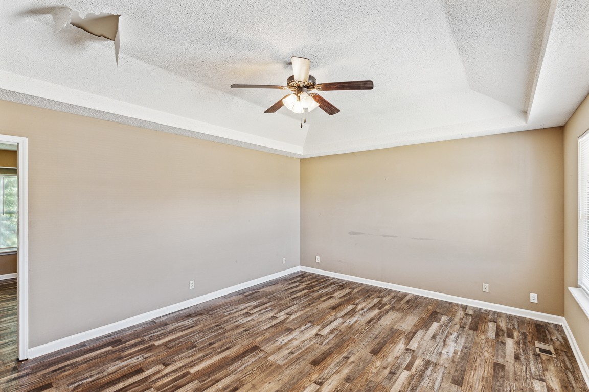 771 Needmore Road Clarksville, TN 37040 - Photo 3 of 15 an empty room with a ceiling fan and wooden floor