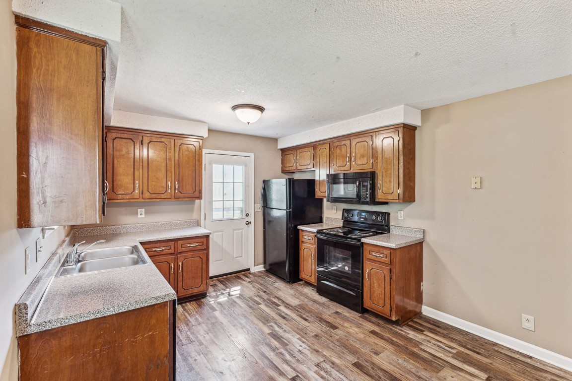 771 Needmore Road Clarksville, TN 37040 - Photo 5 of 15 a kitchen with stainless steel appliances granite countertop a sink stove and refrigerator