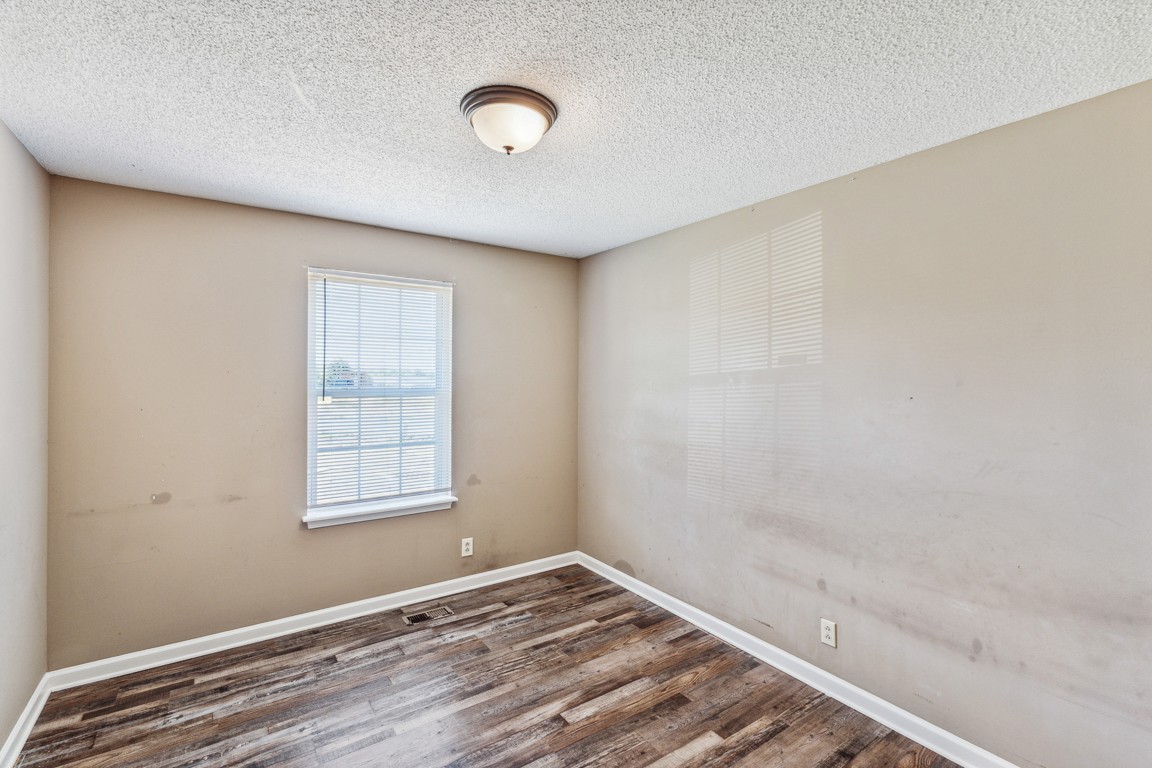 771 Needmore Road Clarksville, TN 37040 - Photo 9 of 15 an empty room with wooden floor and windows