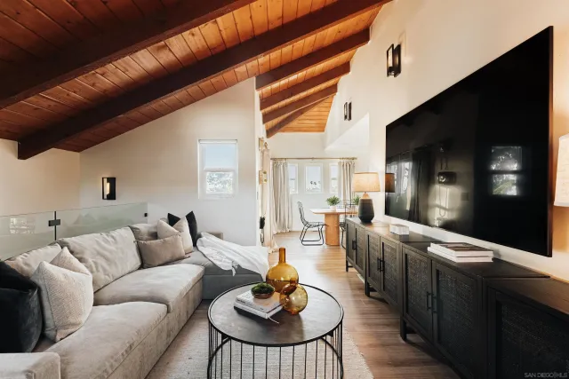 a living room with furniture a flat screen tv and a fireplace