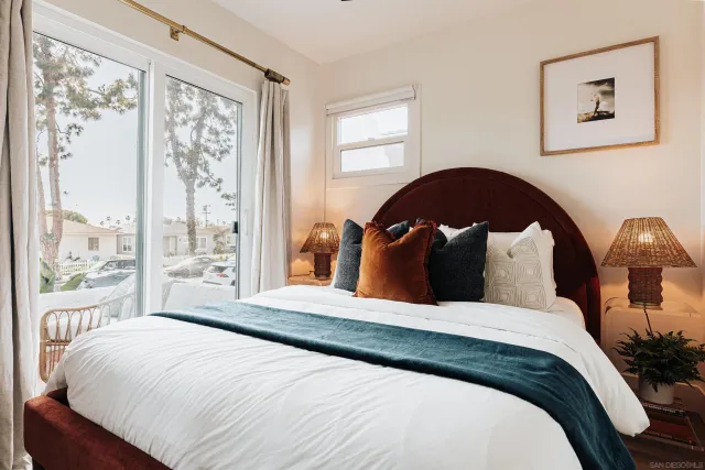 a bedroom with a large bed and a window