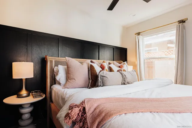 a bed sitting in a bedroom and lamp