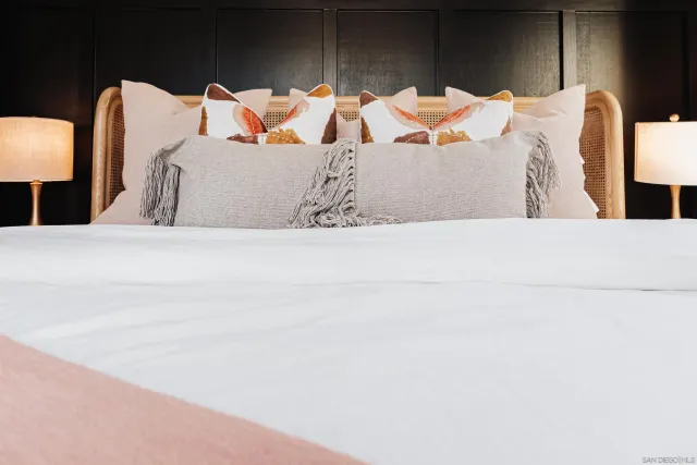 a bed sitting in a bedroom next to a window