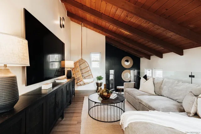 a living room with furniture a rug and a wooden floor