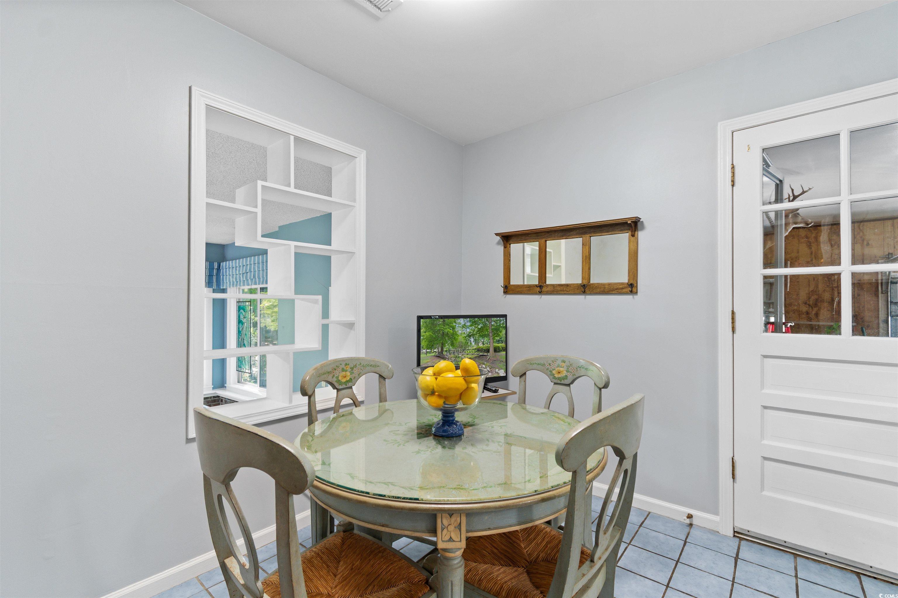 814 2nd Avenue Georgetown, SC 29440 - Photo 16 of 39 Kitchen with white cabinetry, white appliances, light tile patterned flooring, and decorative backsplash