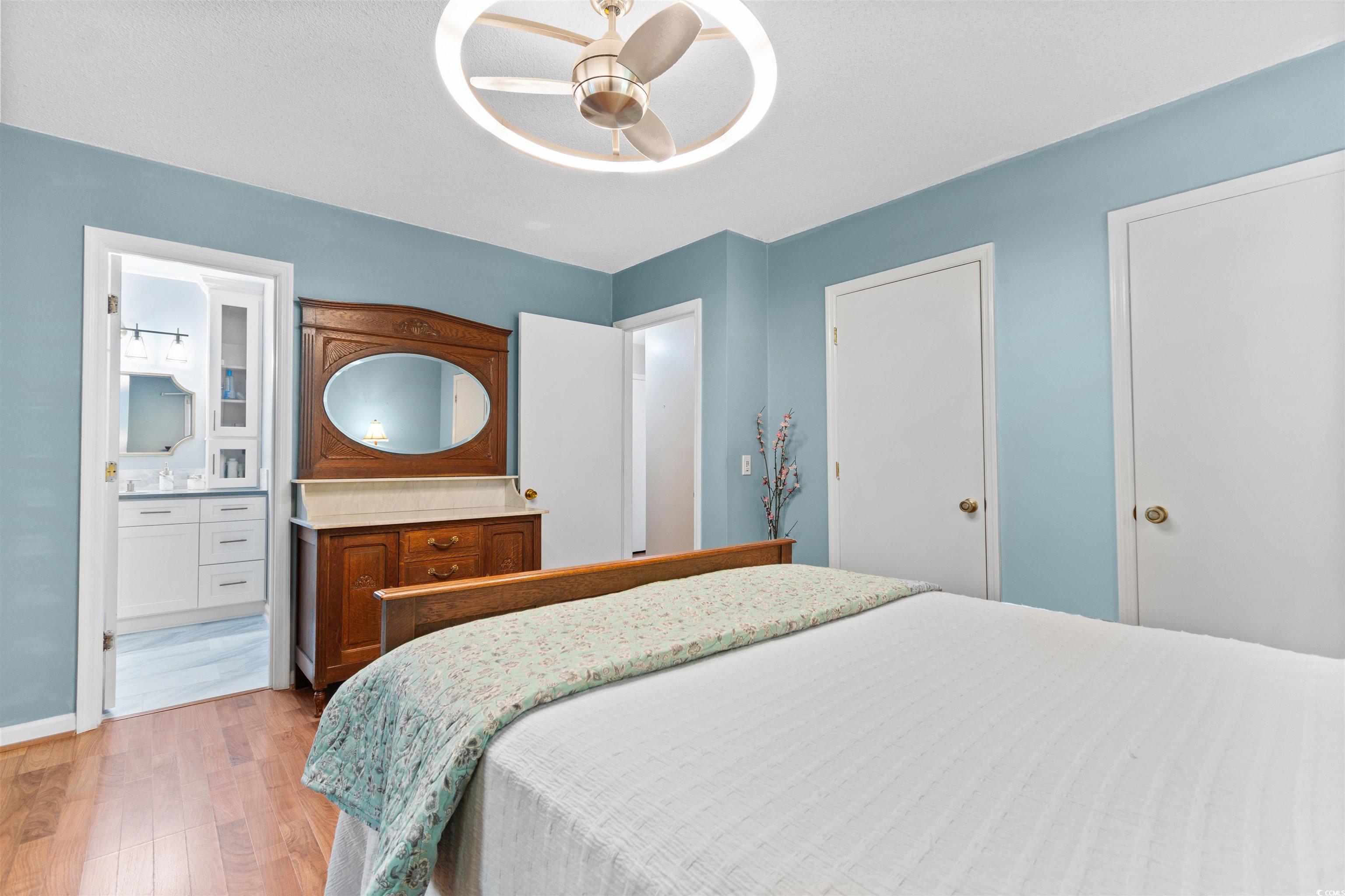 814 2nd Avenue Georgetown, SC 29440 - Photo 18 of 39 Bedroom featuring multiple windows, light wood-type flooring, and a textured ceiling