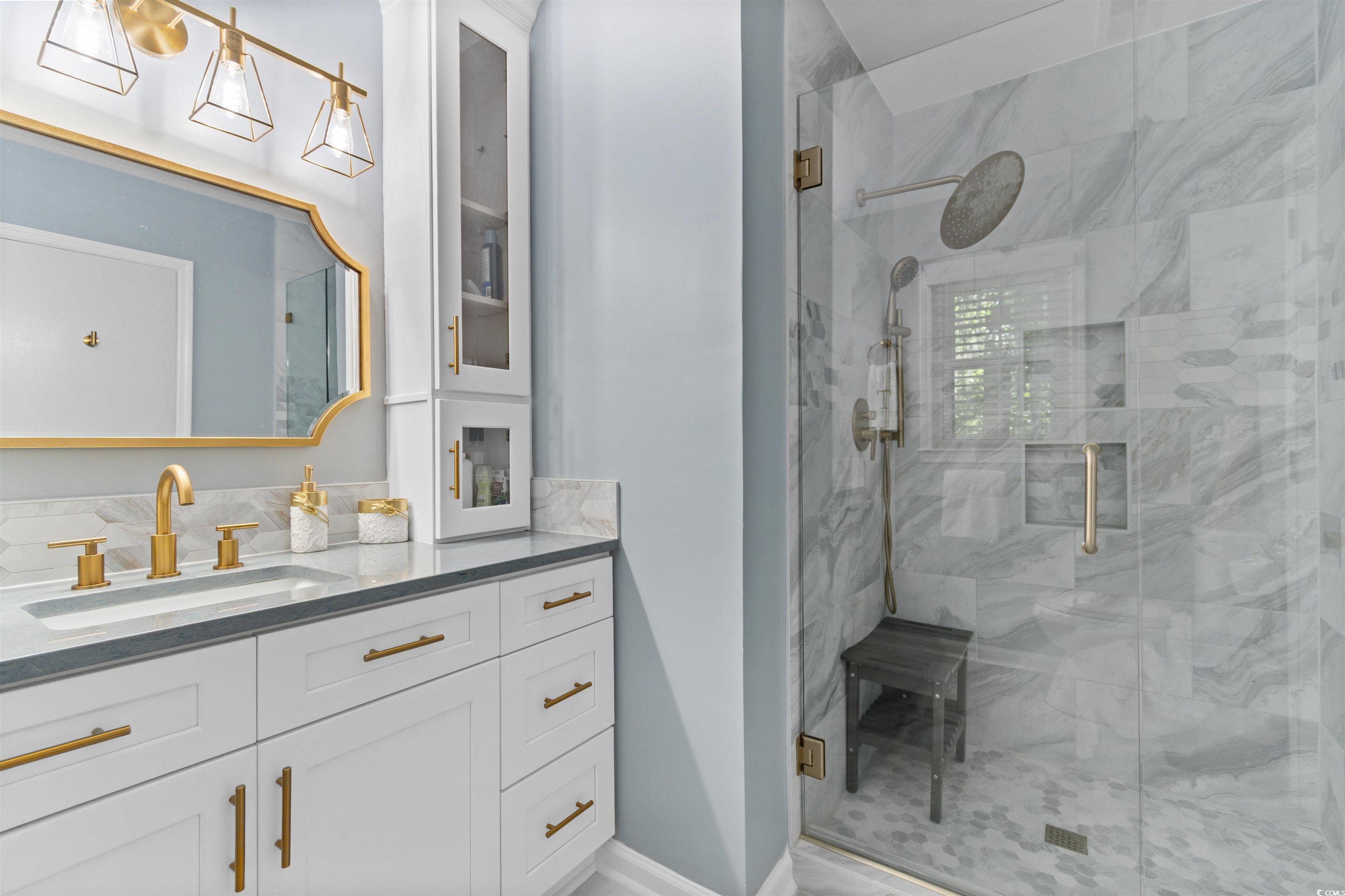 814 2nd Avenue Georgetown, SC 29440 - Photo 19 of 39 Bedroom featuring light wood-style floors, ceiling fan, two closets, and ensuite bathroom