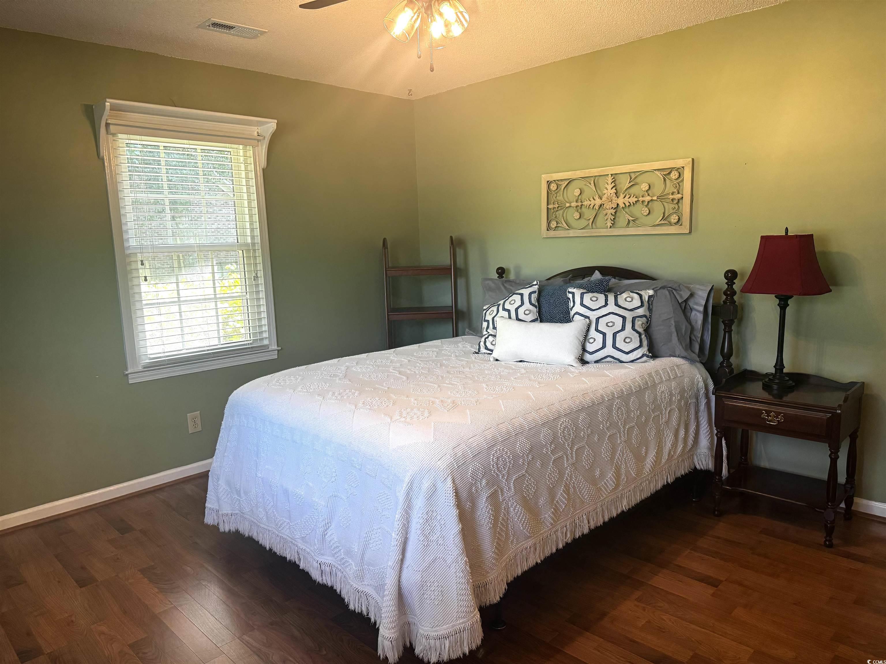 814 2nd Avenue Georgetown, SC 29440 - Photo 23 of 39 Bedroom featuring wood finished floors, crown molding, a textured ceiling, and a closet
