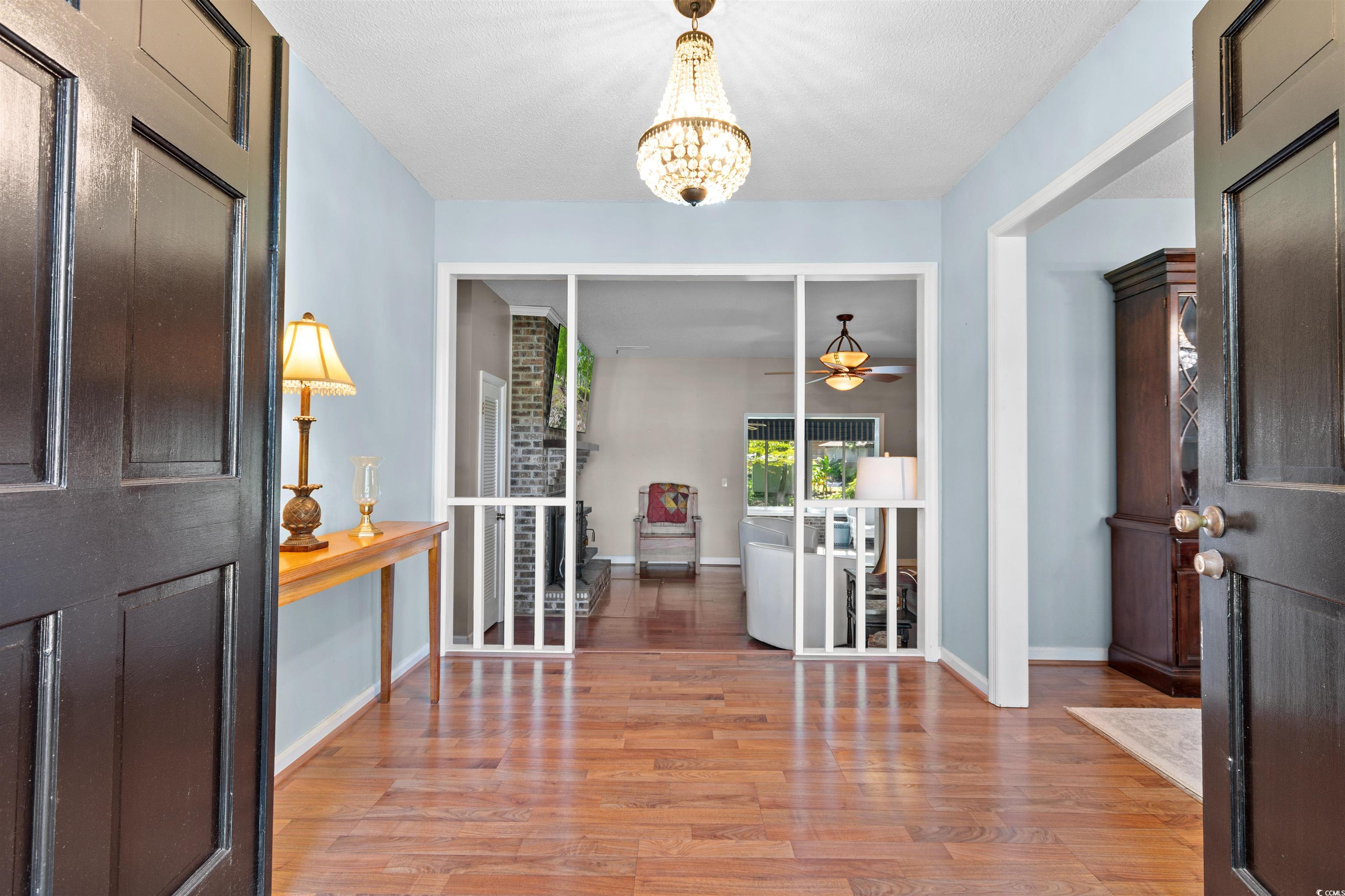 814 2nd Avenue Georgetown, SC 29440 - Photo 5 of 39 Entryway featuring light wood finished floors, a chandelier, and a ceiling fan