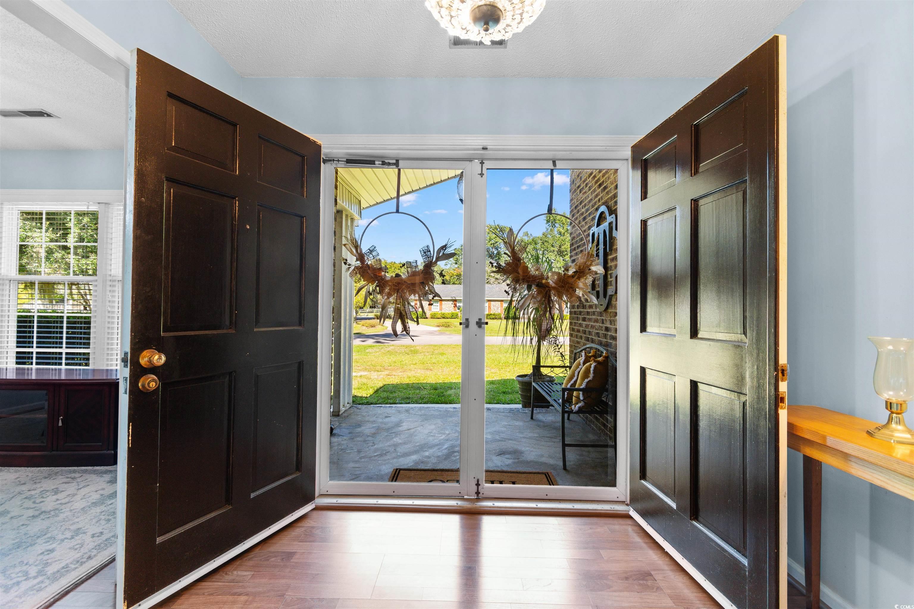 814 2nd Avenue Georgetown, SC 29440 - Photo 6 of 39 Foyer entrance with wood finished floors, a textured ceiling, and a chandelier