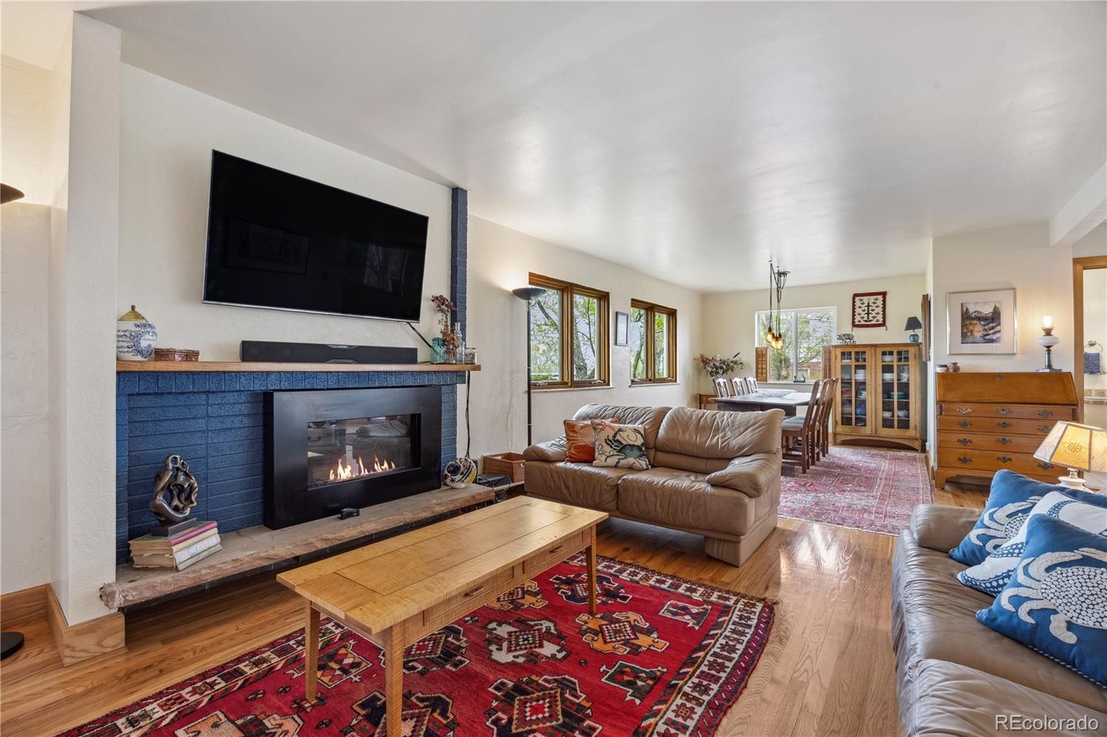 1069 Crestmoor Drive Boulder, CO 80303 - Photo 12 of 45 a living room with furniture a flat screen tv and a fireplace