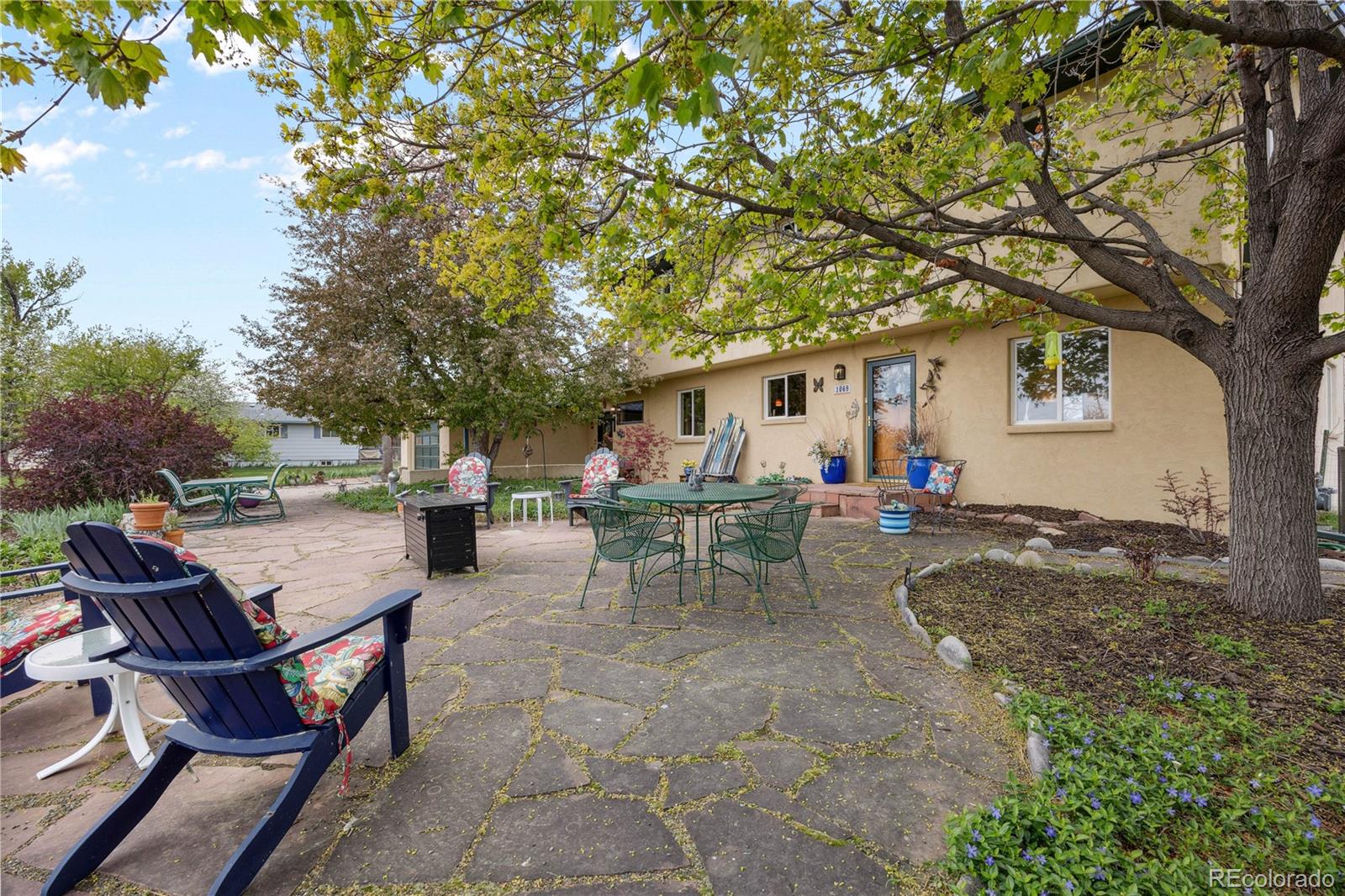 1069 Crestmoor Drive Boulder, CO 80303 - Photo 34 of 45 a backyard of a house with table and chairs