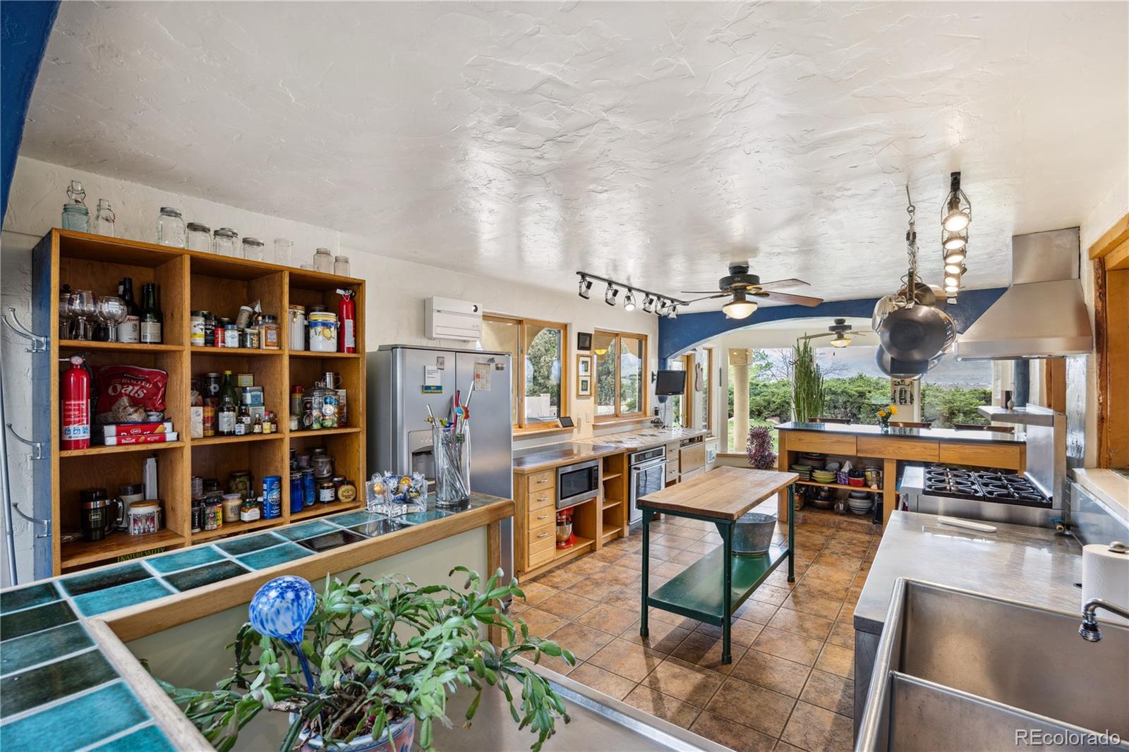 1069 Crestmoor Drive Boulder, CO 80303 - Photo 6 of 45 a living room with lots of furniture and a dining table with potted plants