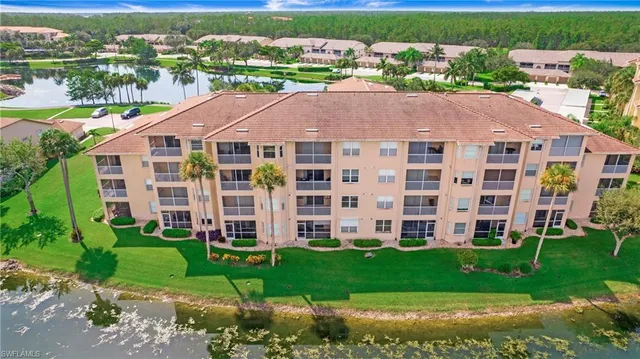 a aerial view of a brick house next to a yard