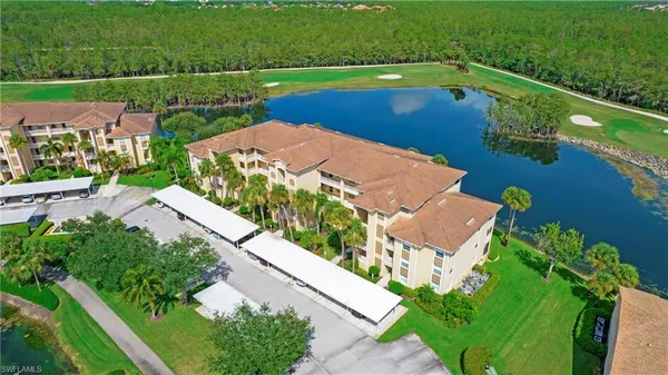 a swimming pool with a yard and palm trees