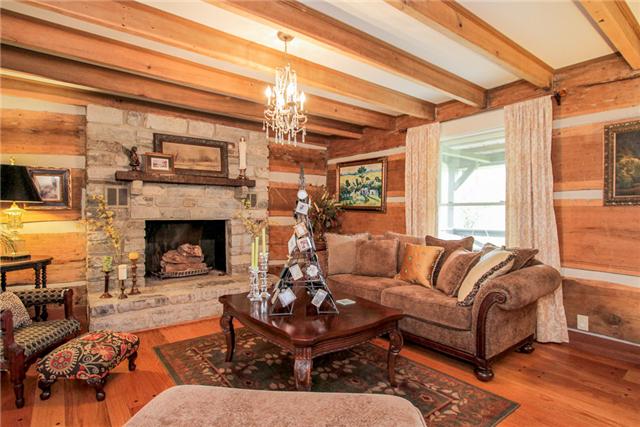2281 Osburn Road Arrington, TN 37014 - Photo 14 of 20 a living room with furniture a large window and a fireplace
