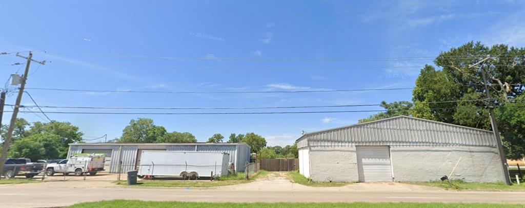 14100 Seagoville Road Dallas, TX 75253 - Photo 5 of 5 Two industrial-style buildings featuring roll-up doors, metal siding, and a gravel driveway