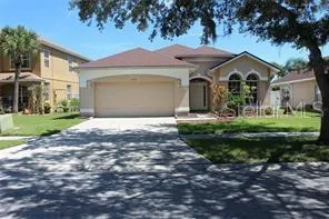 a front view of a house with yard and green space