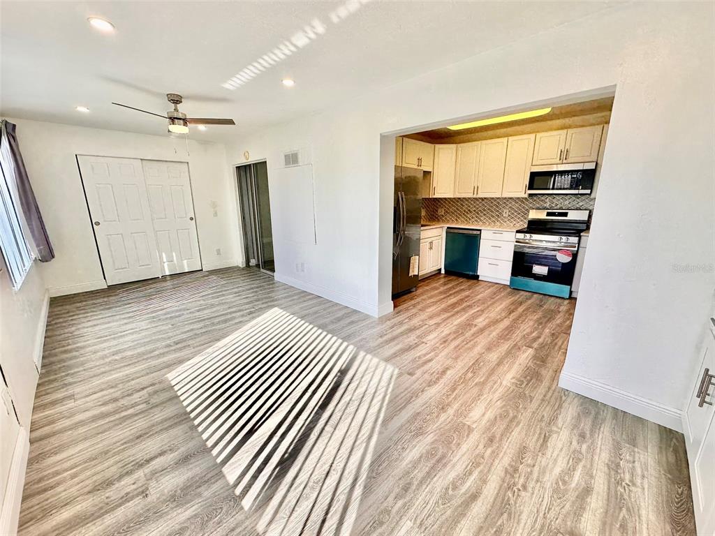2431 Canadian Way, Unit 37 Clearwater, FL 33763 - Photo 11 of 46 an empty room with wooden floor cabinet and windows