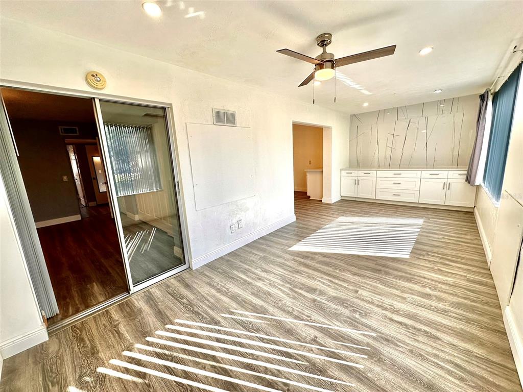 2431 Canadian Way, Unit 37 Clearwater, FL 33763 - Photo 12 of 46 a view of a livingroom with a ceiling fan and wooden floor