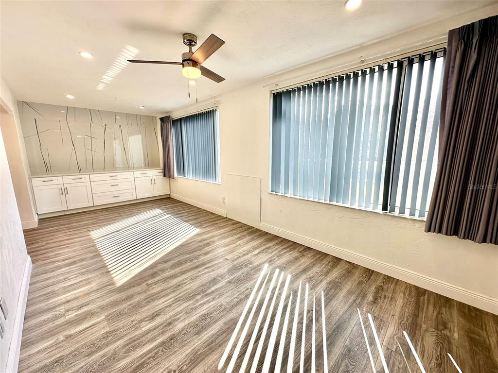 2431 Canadian Way, Unit 37 Clearwater, FL 33763 - Photo 14 of 46 a view of an empty room with wooden floor and a window