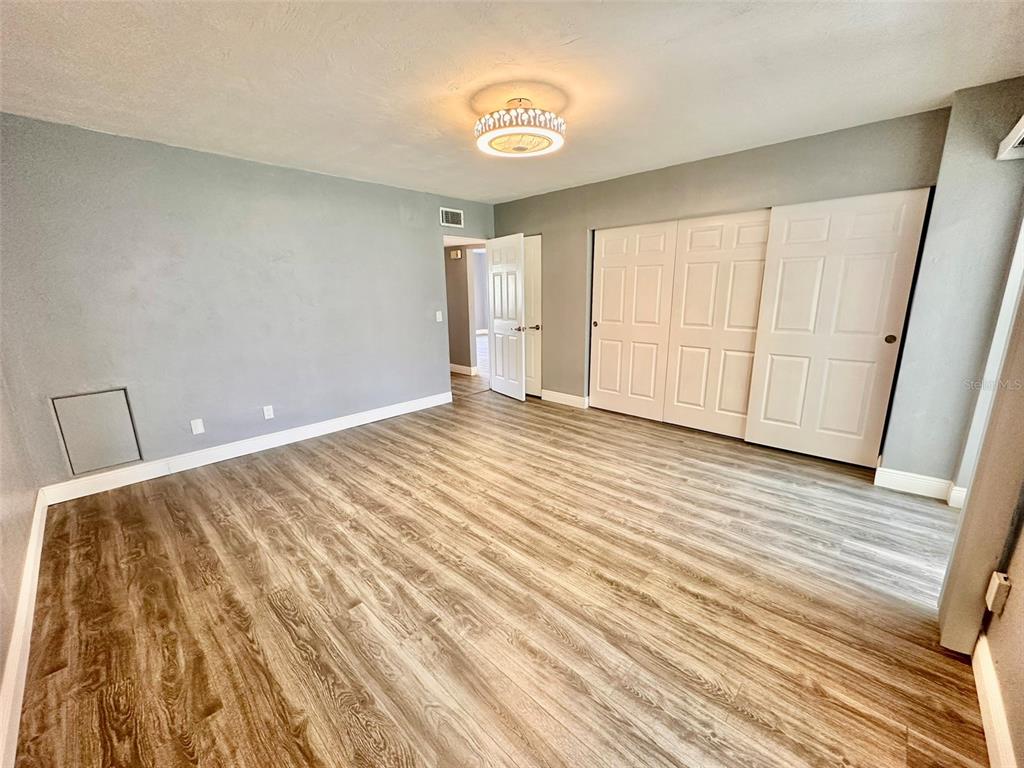 2431 Canadian Way, Unit 37 Clearwater, FL 33763 - Photo 19 of 46 a view of an empty room with wooden floor