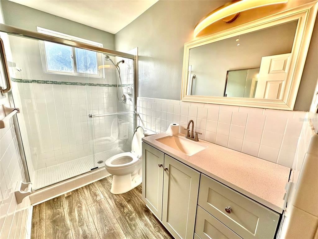 2431 Canadian Way, Unit 37 Clearwater, FL 33763 - Photo 20 of 46 a bathroom with a sink a toilet and shower